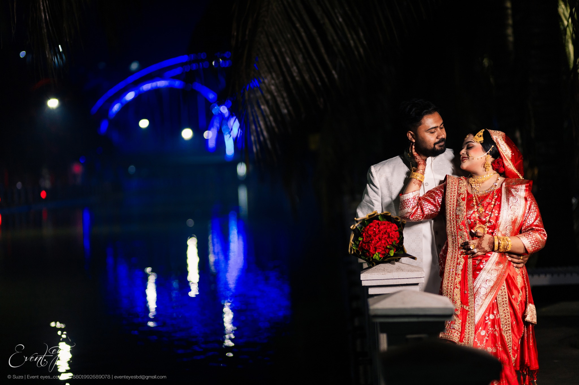 Wedding couple by water at night